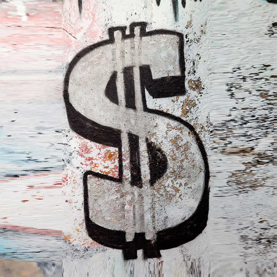 a graffiti dollar sign on an old torn wall