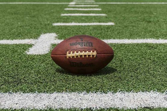 football lying between yard lines on empty field