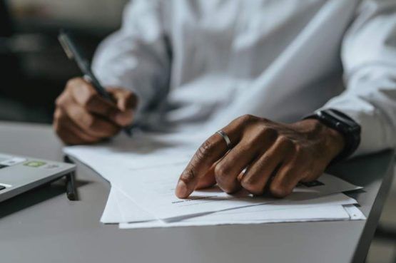 Man writing on paper on court