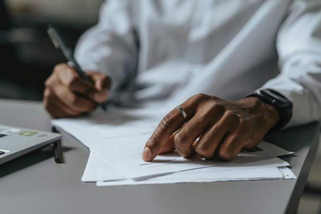 Man writing on paper on court